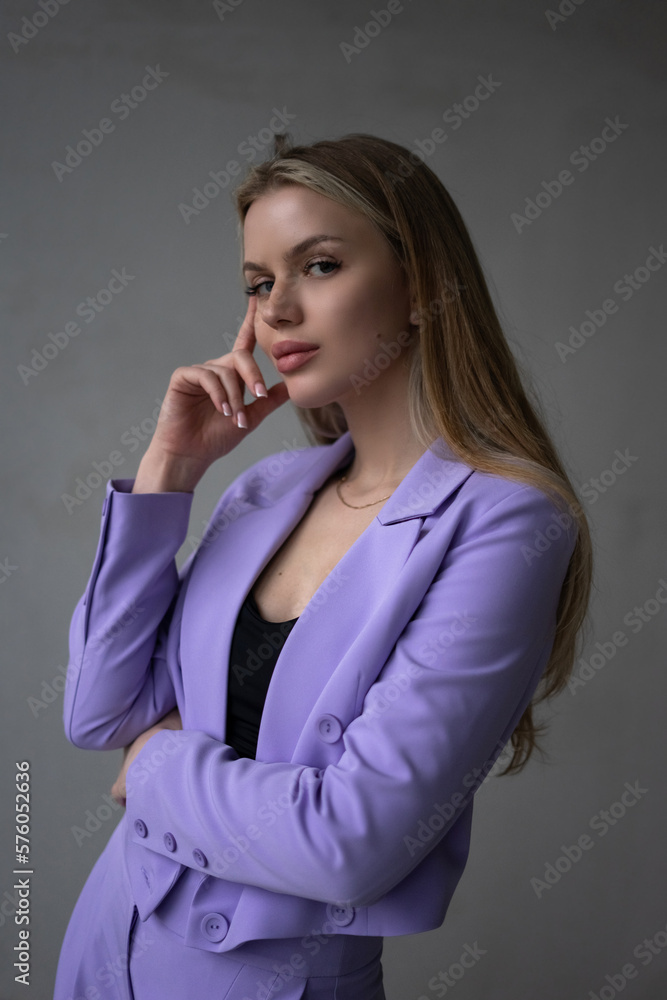Fashion blondie young beauty woman in violet stylish costume. Business woman Fashion blondie young beauty woman in violet stylish costume. Business woman