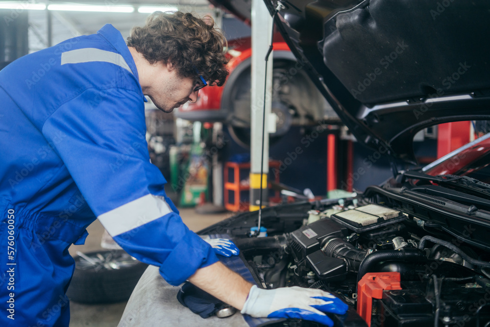 Caucasian auto mechanic man checking and repairing car radiator bonnet in automotive in garage at auto repair shop, motor technician working after vehicle service maintenance concept Caucasian auto mechanic man checking and repairing car radiator bonnet in automotive in garage at auto repair shop, motor technician working after vehicle service maintenance concept