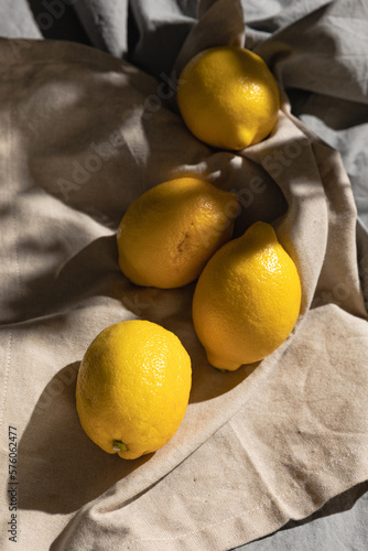 Fresh yellow lemons in the garden under the summer sun