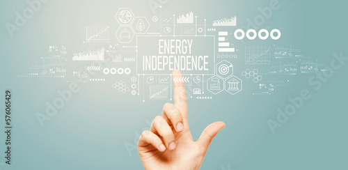 Energy Independence concept with hand pressing a button on a technology screen