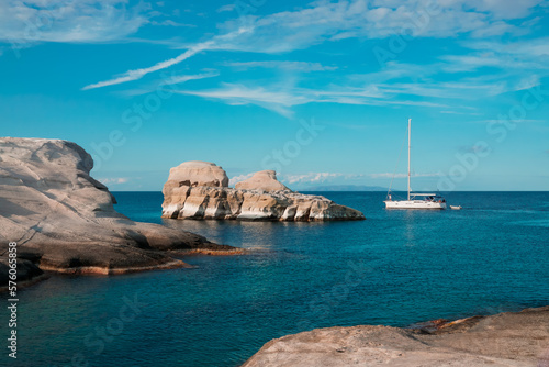A yacht on calm Greek blue sea at Sarakiniko beach on Milos