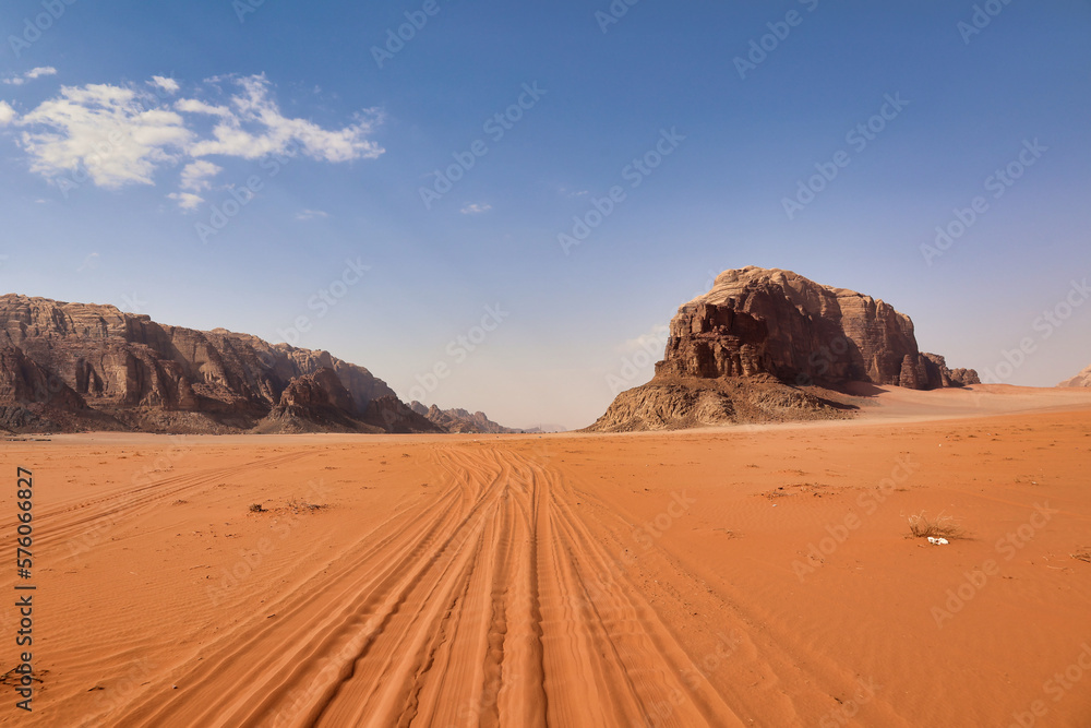 tire tracks in the red sand of jordanian desert wadi rum