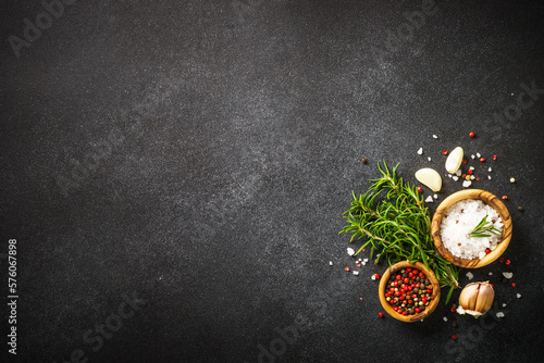 Fototapeta Naklejka Na Ścianę i Meble -  Ingredients for cooking on black stone kitchen table. Herbs, spices and vegetables. Top view with space for design.