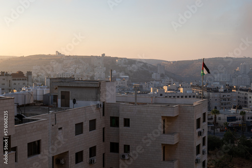 Ramallah Cityscape at Dawn with High Buildings and Mountains Facing the Sun © Alexandre
