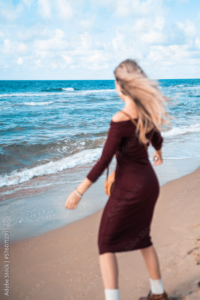 Happy woman on sandy beach smiling. Man on the sea or ocean. Atmospheric photo from a trip or vacation. Nice day. Walk along the coast. Loneliness and connection with nature. Habitat and lifestyle. Happy woman on sandy beach smiling. Man on the sea or ocean. Atmospheric photo from a trip or vacation. Nice day. Walk along the coast. Loneliness and connection with nature. Habitat and lifestyle.