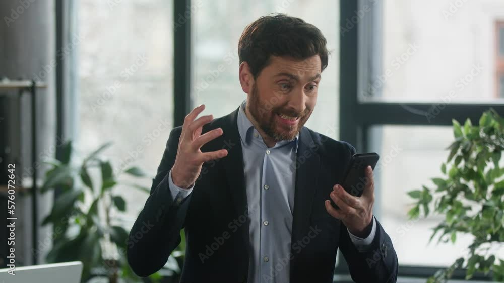 Angry furious businessman using phone in office loses online lottery losing bet on internet worried to bad result financial loss stressed upset man entrepreneur disappointed failure fails in business Angry furious businessman using phone in office loses online lottery losing bet on internet worried to bad result financial loss stressed upset man entrepreneur disappointed failure fails in business