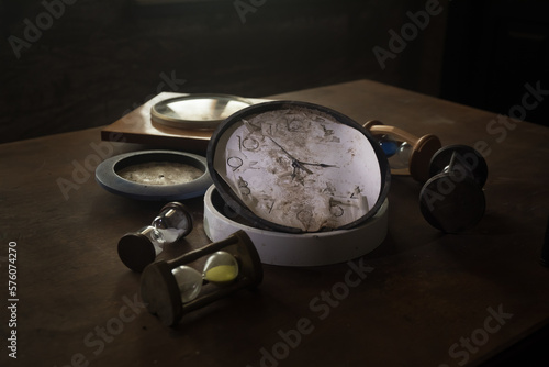 Time concept. Old rustic wall clock on old wooden table with copy space