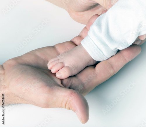 Father holding newborn baby in hands feet © fabio