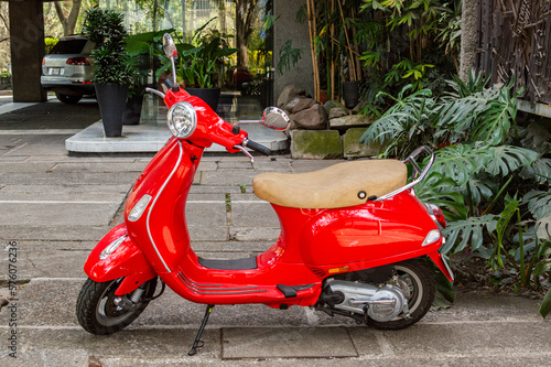 red scooter parked on the street