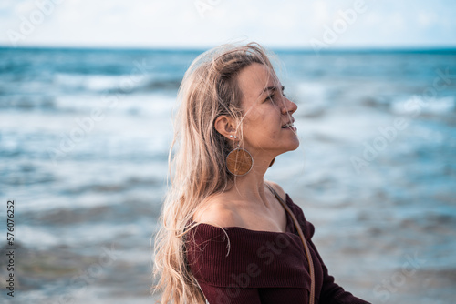 Woman on the sandy beach. Man on the sea or ocean. Atmospheric photo from a trip or vacation. Nice day. Walk along the coast. Loneliness and connection with nature. Habitat and lifestyle.