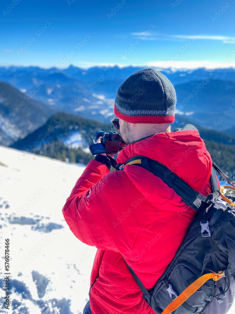 Bavarian Hiker life with camera photo shooting at snow landscape