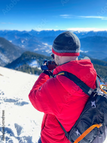 Bavarian Hiker life with camera photo shooting at snow landscape