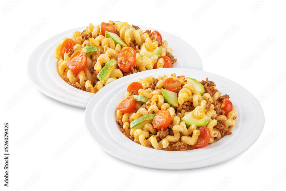 Minced beef zucchini tomatoes pasta in a plate on a white isolated background Minced beef zucchini tomatoes pasta in a plate on a white isolated background