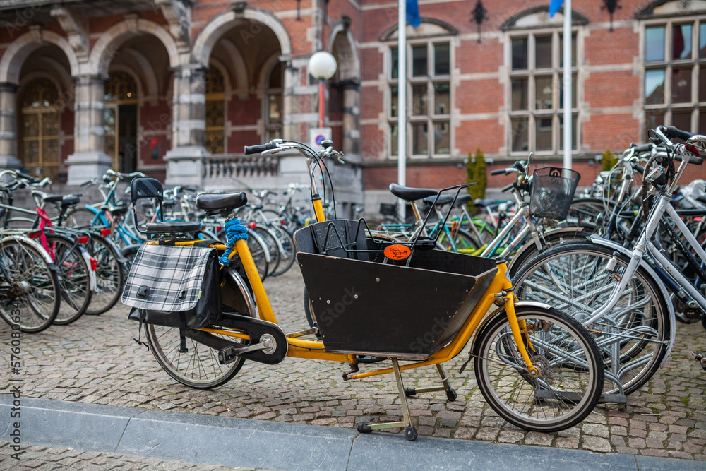 Pretty yellow cargo bike on the street of Groningen, Netherlands