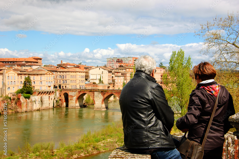 Senior couple admiring river view in medieval town of Albi, Roussillon-Languedoc, France. Springtime tourism background.