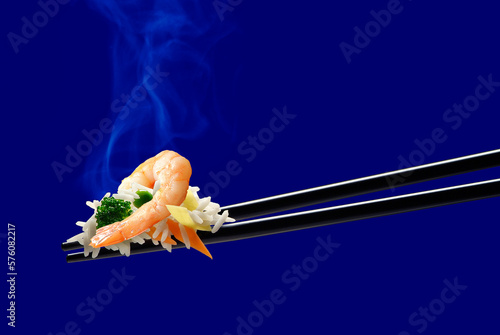 Basmati rice with shrimp and vegetables on chopsticks