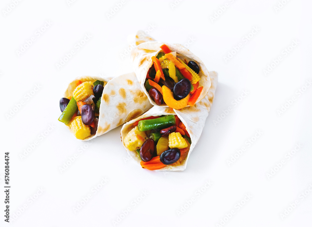 Mexican tortilla with vegetable fillings on white background. Close-up
