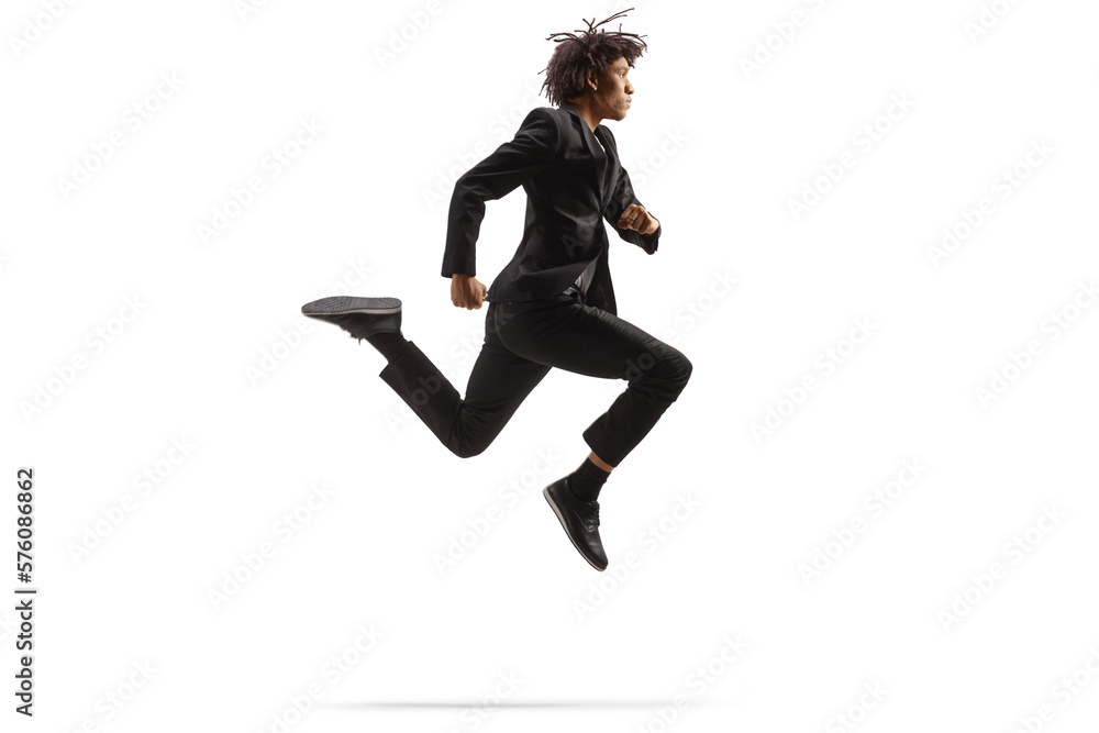 Full length profile shot of an african american man in a black suit jumping