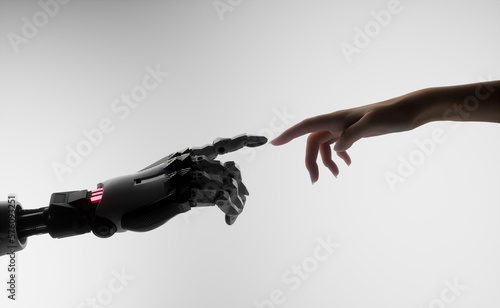 Silhouette of female hand touching the hand of a robot against white background 