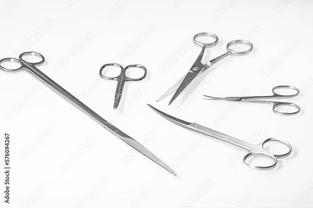 Set of various scissors for a hairdresser on a light background