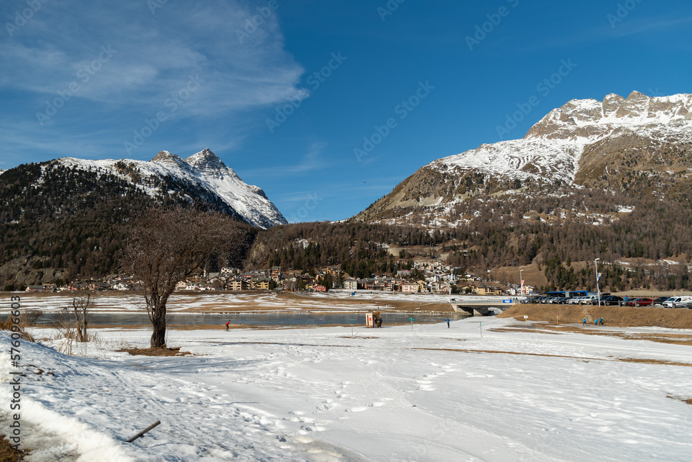 View over the frozen lake of Silvaplana with a beautiful winter panorama in Switzerland