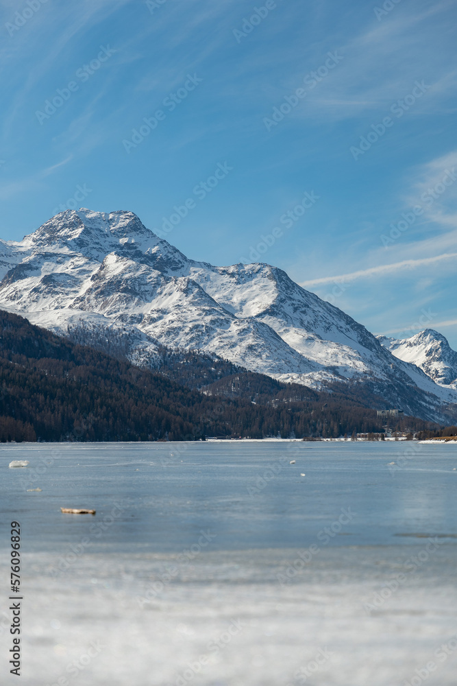 View over the frozen lake of Silvaplana and the peak of the mount Corvatsch in the background View over the frozen lake of Silvaplana and the peak of the mount Corvatsch in the background