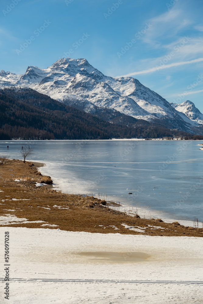 View over the frozen lake of Silvaplana and the peak of the mount Corvatsch in the background