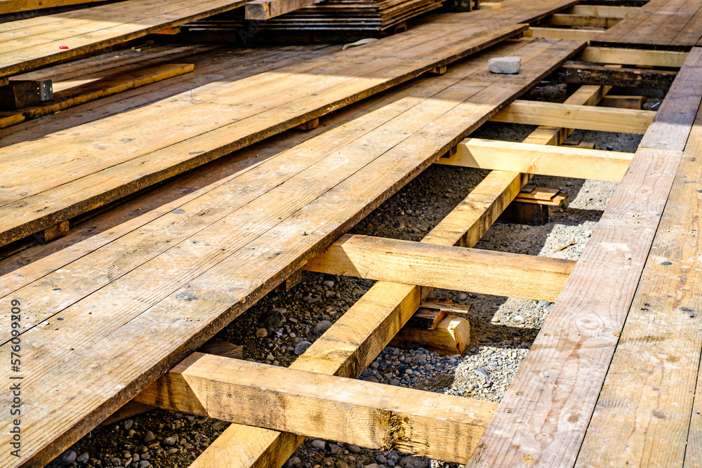 heap of wooden planks at a construction site heap of wooden planks at a construction site