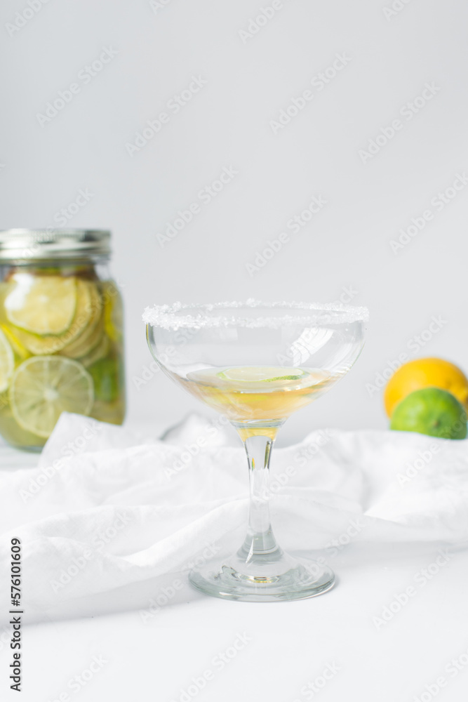 Lime cocktail in a coupe glass, citrus cocktail on  a white table