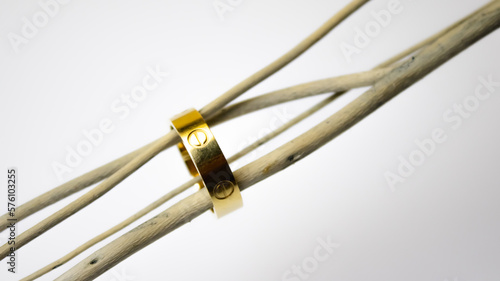 golden bracelet with a ring on a white background, jewelry concept
