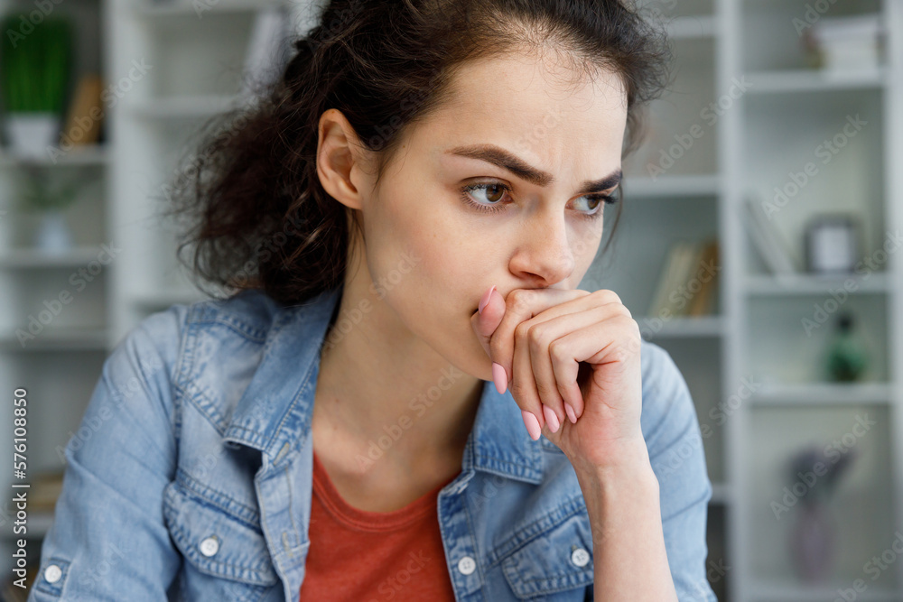 Young curly brunette sits stressed at the table feeling apathy and depression from overwork at work. Burnout from the modern world. Problems in life, bad news. Young curly brunette sits stressed at the table feeling apathy and depression from overwork at work. Burnout from the modern world. Problems in life, bad news.
