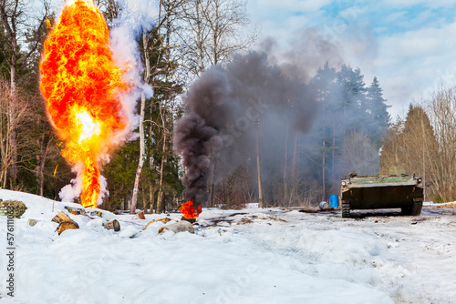 russian military tank with soldiers in ukraine in winter goes on the attack under fire