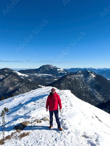 Hiker at the Jochberg peak with the Walchensee lake at the background landscape