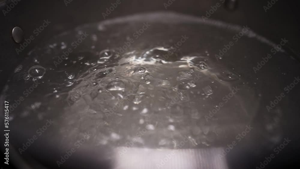 Water is boiling in a pot on the stove. Boiling water in slow motion. Water is boiling in a pot on the stove. Boiling water in slow motion.