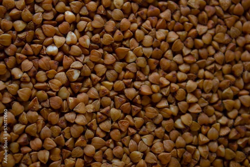 Background of buckwheat groats top view. Buckwheat is a source of carbohydrates and is great for a diet. Healthy food concept. Roasted buckwheat seeds as a background. Background of buckwheat groats top view. Buckwheat is a source of carbohydrates and is great for a diet. Healthy food concept. Roasted buckwheat seeds as a background.