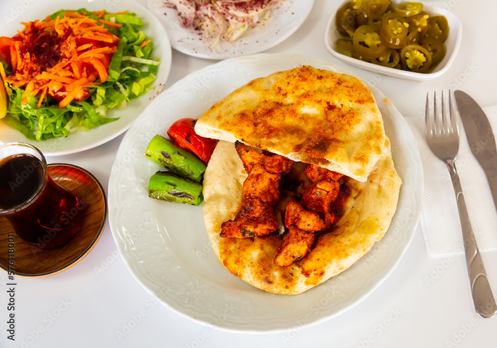 Traditional chicken kebab, tortillas and stewed vegetables. Turkish cuisine