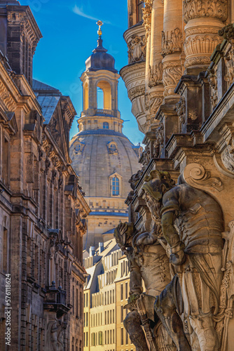 Cityscape - street view with sculptures of gatekeepers on the George Gate of Dresden Castle against the backdrop of the Dresden Frauenkirche, Dresden, Germany