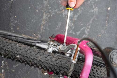 A close-up of screwdriver tool to adjust and repair bicycle crank assembly