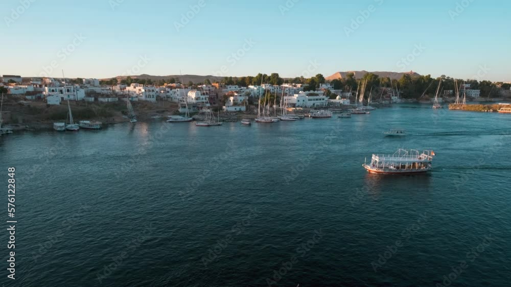 Nile river in Aswan, Egypt afternoon shot showing feluccas and boats in the river with elephantine Island (UNESCO World Heritage site) Nile river in Aswan, Egypt afternoon shot showing feluccas and boats in the river with elephantine Island (UNESCO World Heritage site)