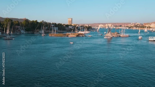 Nile river in Aswan, Egypt afternoon shot showing feluccas and boats in the river with elephantine Island (UNESCO World Heritage site)