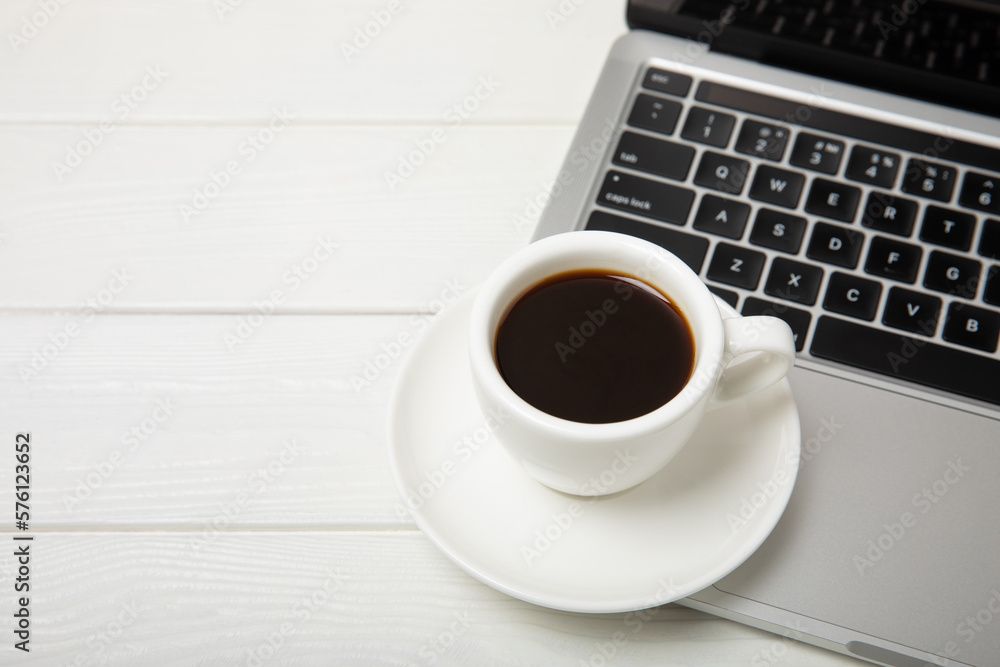 A laptop with a cup of strong aroma coffee on a working office desk. Workspace with copy space. Mocap. Business concept. Place for text. Flat lay A laptop with a cup of strong aroma coffee on a working office desk. Workspace with copy space. Mocap. Business concept. Place for text. Flat lay