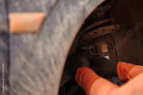 Replacement and repair of wheels and shock absorbers on a car in a garage