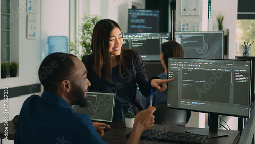 Plakat w ramie Team of diverse programers doing highfive gesture after coding database, celebrating cloud computing achievement. Successful firewall server development with it software language.