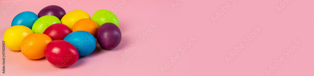 Wide Easter banner empty. Multi-colored eggs on a pink background. Holiday concept, congratulation, postcard, template,copy space, text, moc-up,handmade,spring,decoration,party,poste, blank, party. Wide Easter banner empty. Multi-colored eggs on a pink background. Holiday concept, congratulation, postcard, template,copy space, text, moc-up,handmade,spring,decoration,party,poste, blank, party.