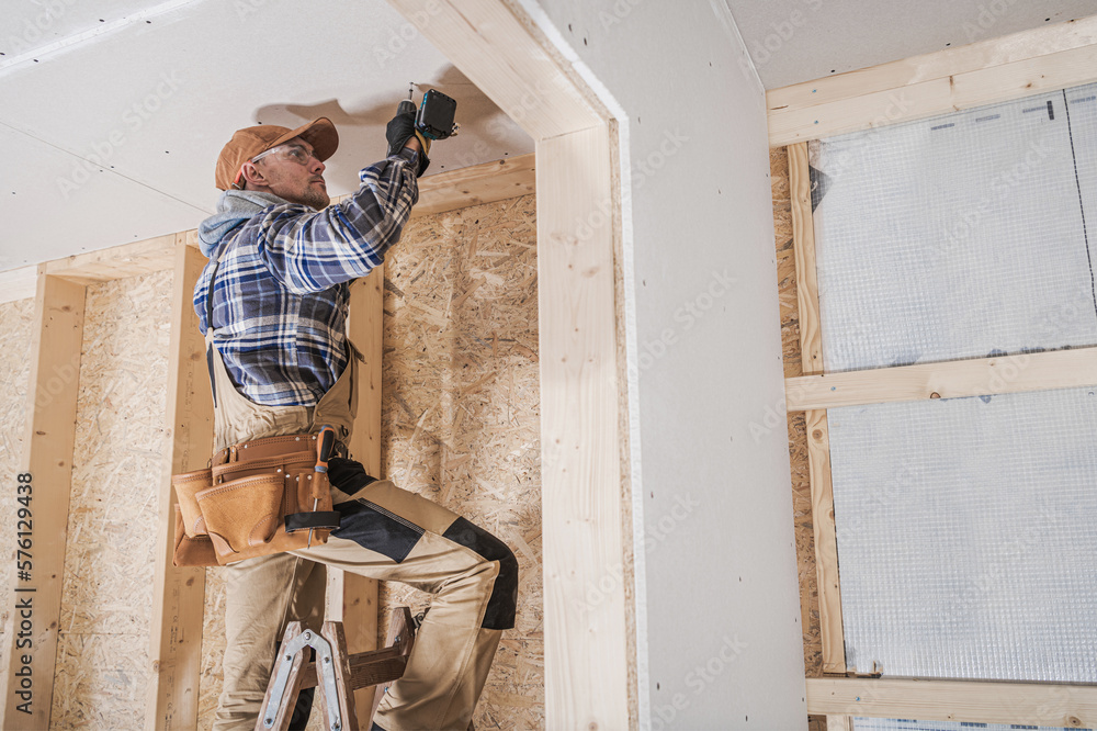 General Construction Contractor Worker Attaching Drywall Using Drill Driver - obrazy, fototapety, plakaty 