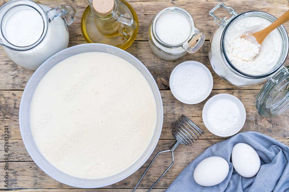 ingredients for making dough on a wooden table for pancakes, top view ingredients for making dough on a wooden table for pancakes, top view