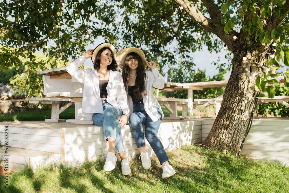 Beautiful garden. Girls pose in the garden. Beautiful garden. Girls pose in the garden.