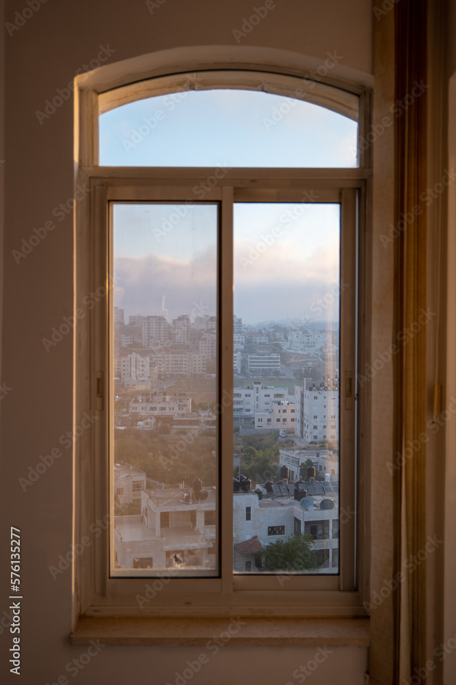 Window with Ramallah Cityscape at Dawn with High Buildings and Trees Window with Ramallah Cityscape at Dawn with High Buildings and Trees
