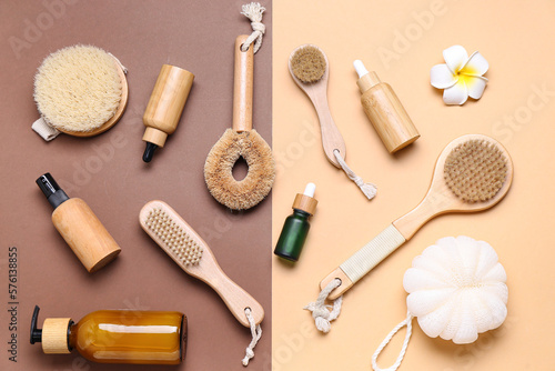 Composition with different massage brushes, sponge and cosmetic products on color background