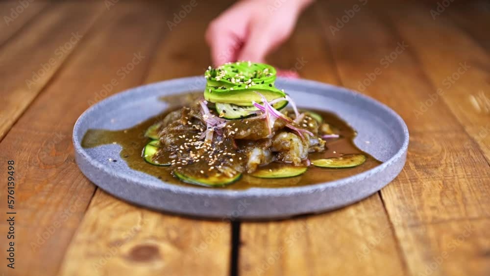 Aguachile plate, traditional Mexican dish on a wooden table. Aguachile plate, traditional Mexican dish on a wooden table.